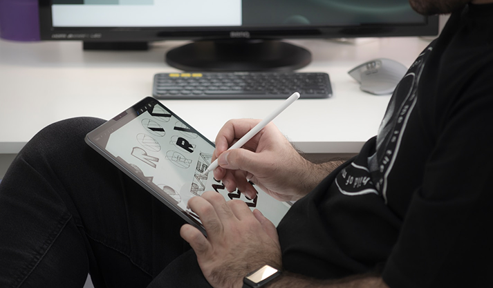 Man writing on Tablet